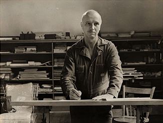 Rockwell Kent working at a drafting table