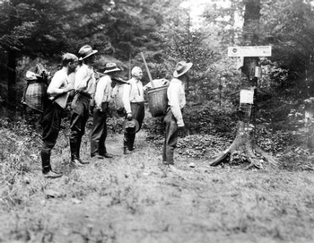 Men using pack baskets to hike Marcy, NYS Archives